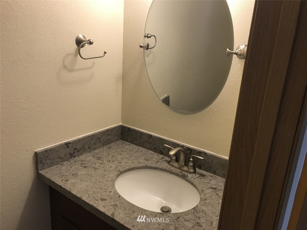115 Union Avenue Northeast Renton, WA 98059 - Photo 11 of 20 a bathroom with a granite countertop sink a mirror and shower