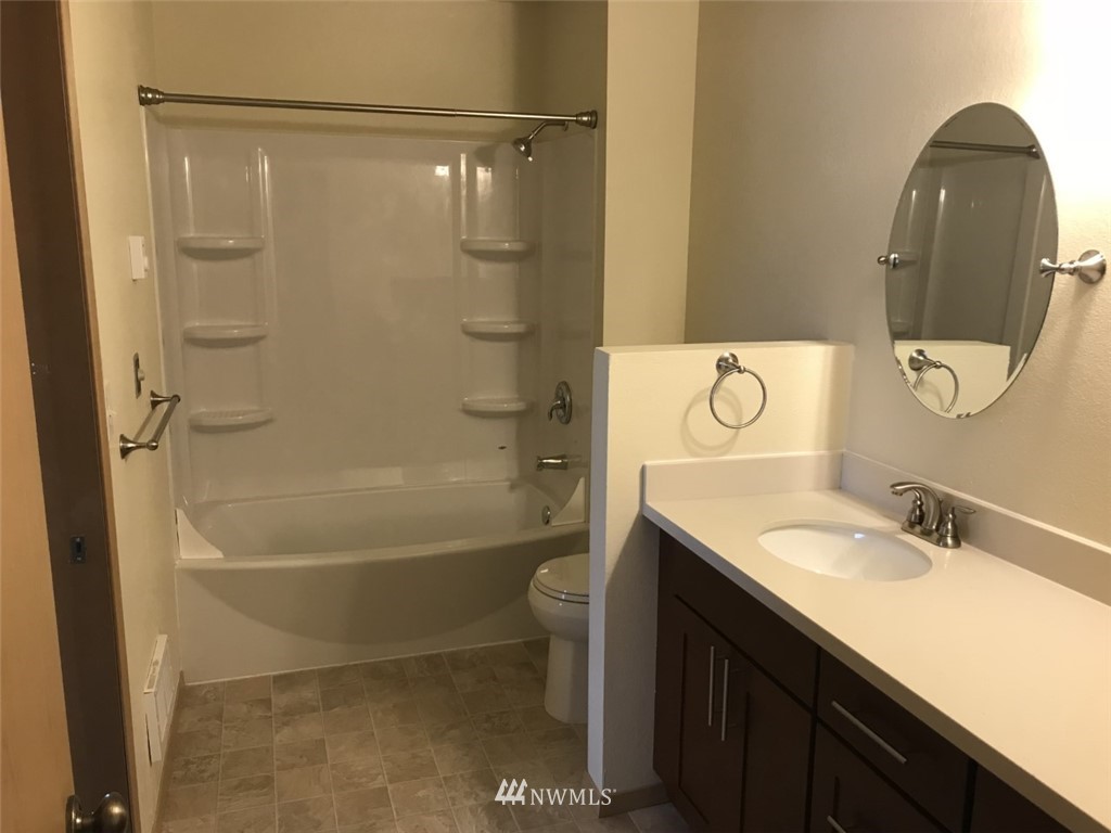 115 Union Avenue Northeast Renton, WA 98059 - Photo 18 of 20 a bathroom with a granite countertop sink a toilet and shower