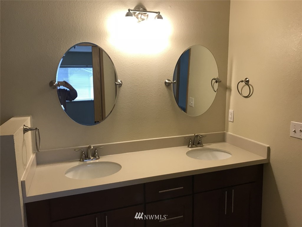 115 Union Avenue Northeast Renton, WA 98059 - Photo 19 of 20 a bathroom with a double vanity sink and a mirror
