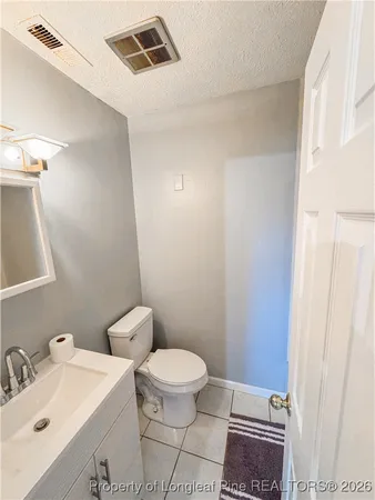 a bathroom with a toilet a sink and a mirror