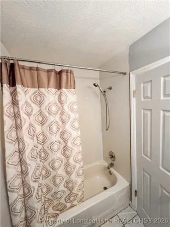 a bathroom with a bathtub and shower