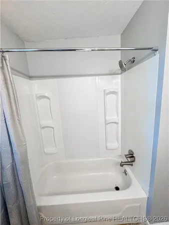 a bathroom with a shower and a bath tub