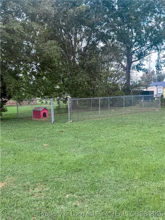 a backyard of a house with lots of green space and plants