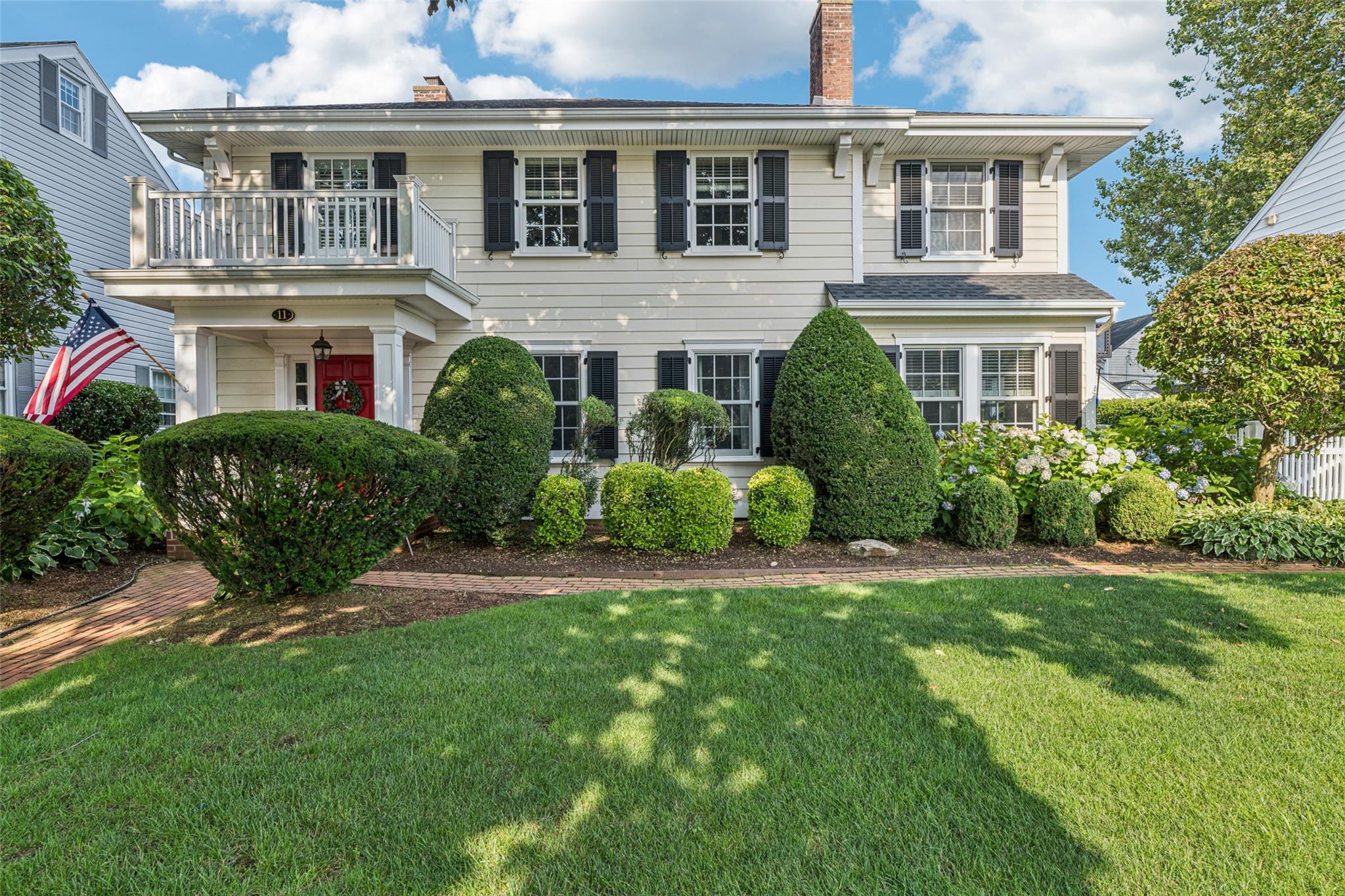 11 Wellington Road Garden City, NY 11530 - Photo 1 of 1 a front view of a house with a yard
