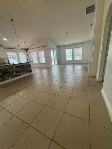 a large kitchen with stainless steel appliances a large counter top a stove a chimney a sink and a refrigerator