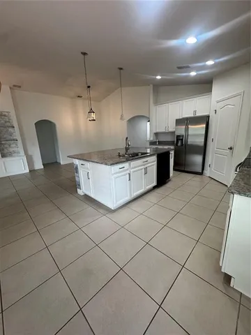 a kitchen with a sink a stove and cabinets