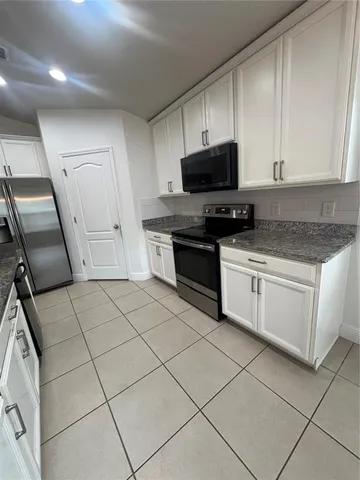 a kitchen with kitchen island a counter space a sink and appliances