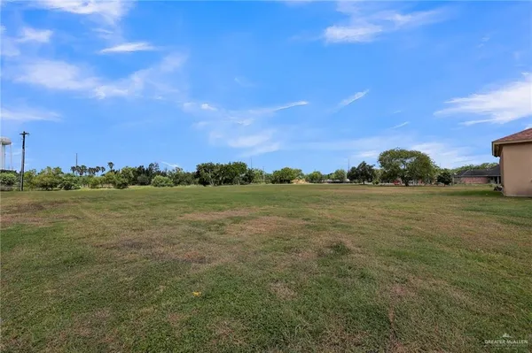 a view of a field with ocean view