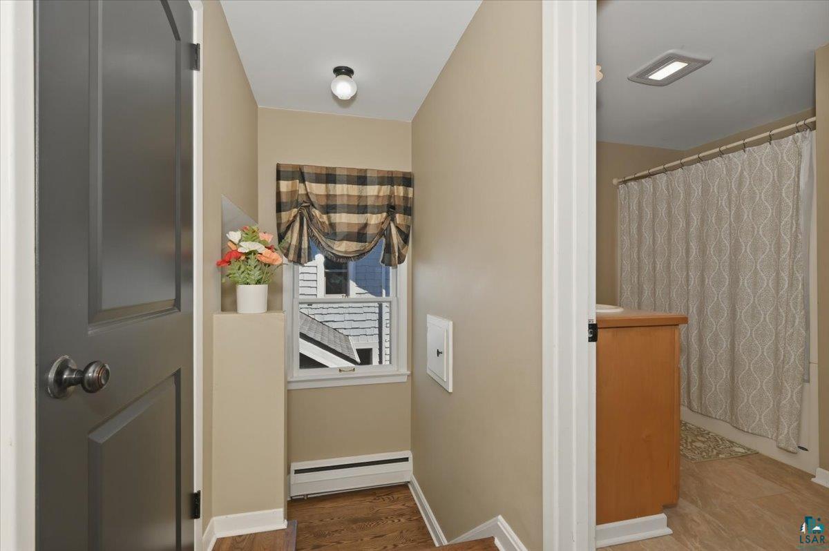 1918 West Kent Road Duluth, MN 55812 - Photo 18 of 42 Hallway featuring wood-finish flooring and a window with a valance
