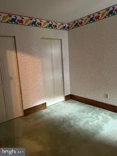 a view of small space with wooden floor and cabinet