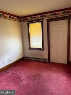 a view of a room with window and a wooden floor