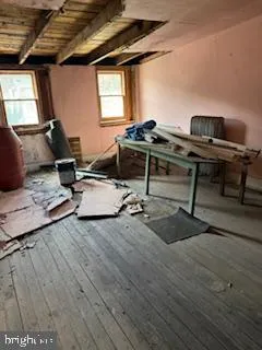 a view of a livingroom with wooden floor and a ceiling fan