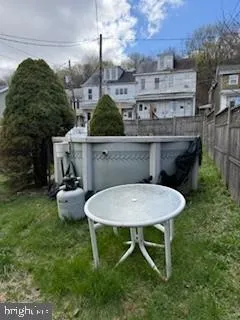 a backyard of a house with table and chairs
