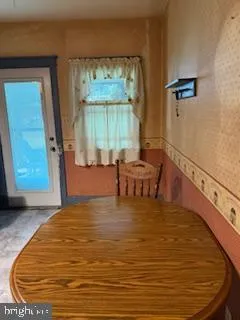 a view of a room with furniture and wooden floor