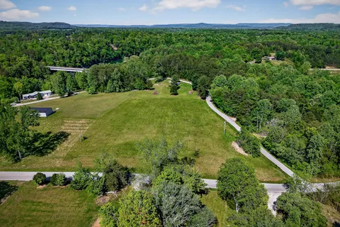 an aerial view of a house with garden space and street view