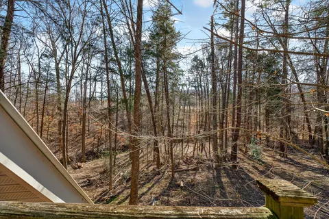 a backyard of a house with barbeque oven table and chairs