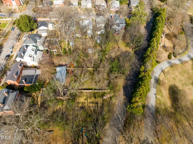 an aerial view of residential houses with yard