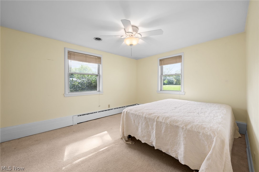 8106 Middlesex Road Mentor, OH 44060 - Photo 18 of 32 Bedroom with baseboard heating, carpet floors, and multiple windows