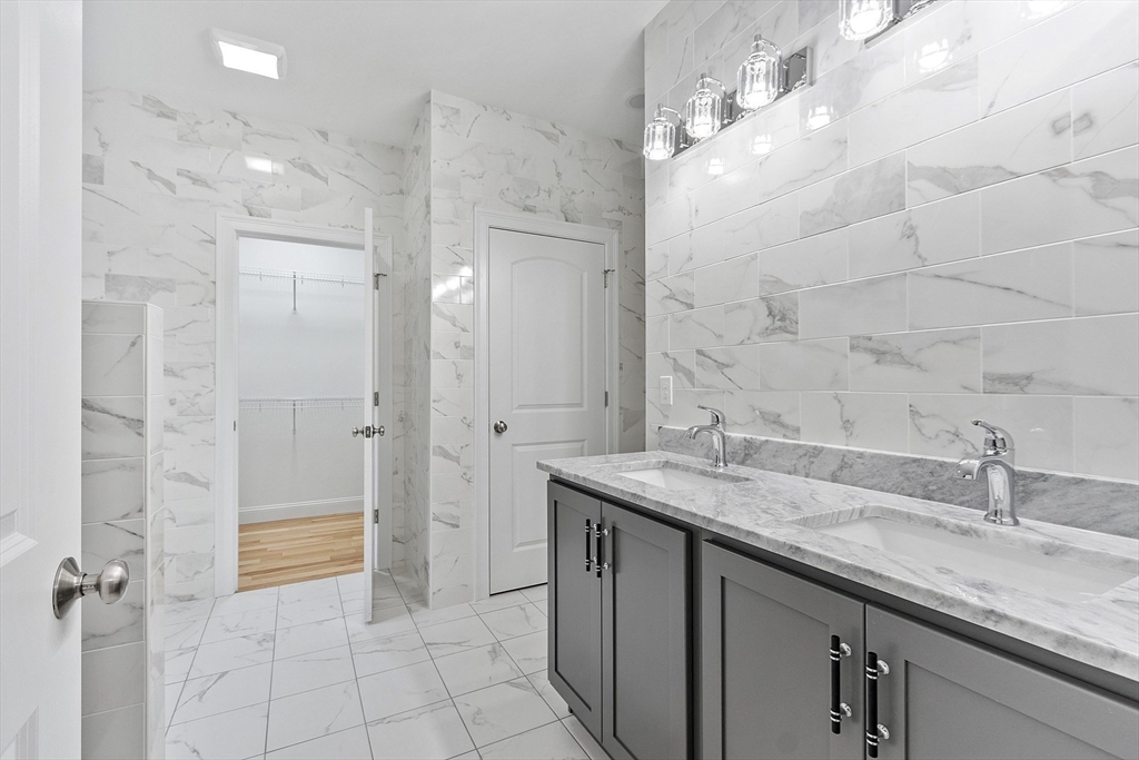 186 Justice Hill Road, Unit OAKMONT Sterling, MA 01564 - Photo 18 of 34 a bathroom with a sink double vanity and shower