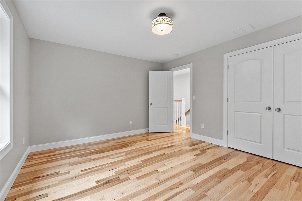 186 Justice Hill Road, Unit OAKMONT Sterling, MA 01564 - Photo 27 of 34 a view of a room with wooden floor and closet