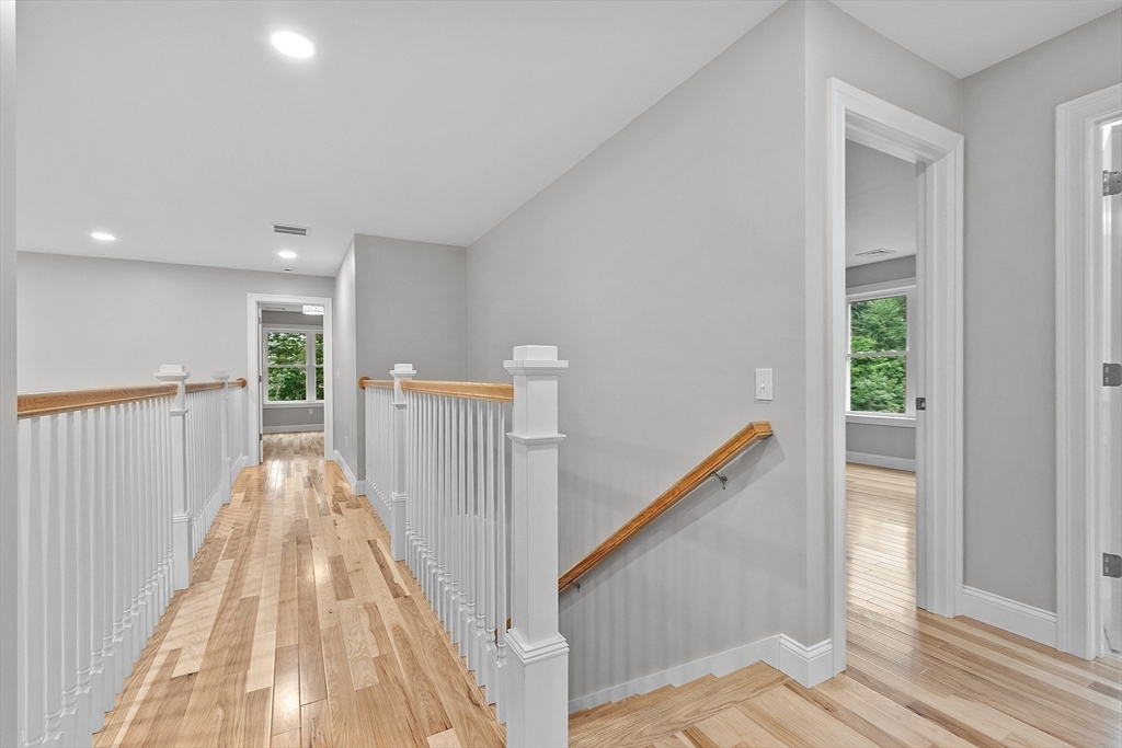 186 Justice Hill Road, Unit OAKMONT Sterling, MA 01564 - Photo 28 of 34 a view of a hallway with wooden floor and stairs