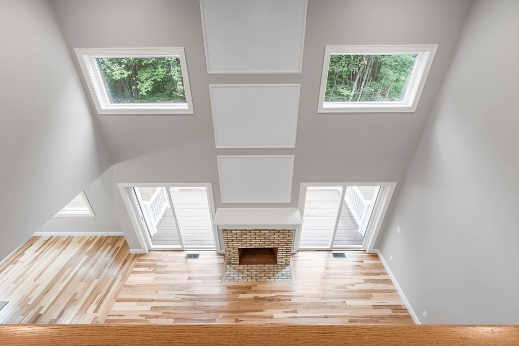 186 Justice Hill Road, Unit OAKMONT Sterling, MA 01564 - Photo 29 of 34 a view of a livingroom with a fireplace and window