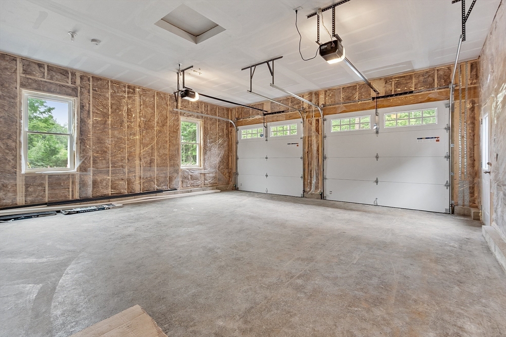 186 Justice Hill Road, Unit OAKMONT Sterling, MA 01564 - Photo 34 of 34 an empty room with windows and entrance