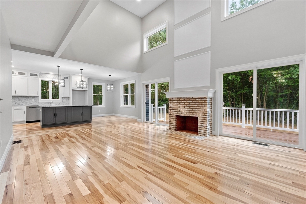 186 Justice Hill Road, Unit OAKMONT Sterling, MA 01564 - Photo 4 of 34 a view of a livingroom with a fireplace a ceiling fan and windows
