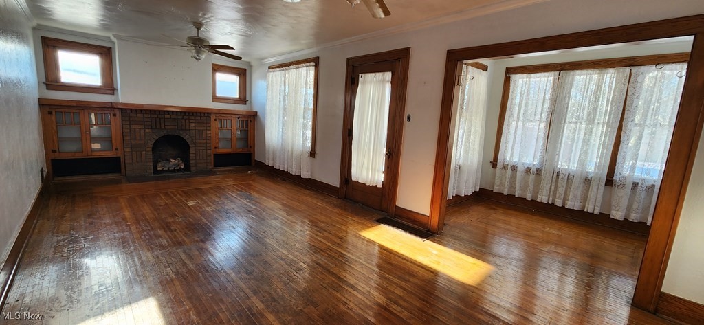 125 Rockdale Road Follansbee, WV 26037 - Photo 4 of 19 Unfurnished living room with ceiling fan, hardwood / wood-style flooring, a fireplace, and crown molding