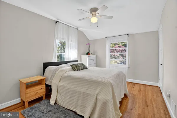 a bedroom with a bed dresser and a window