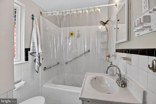 a bathroom with a sink a toilet and a bathtub