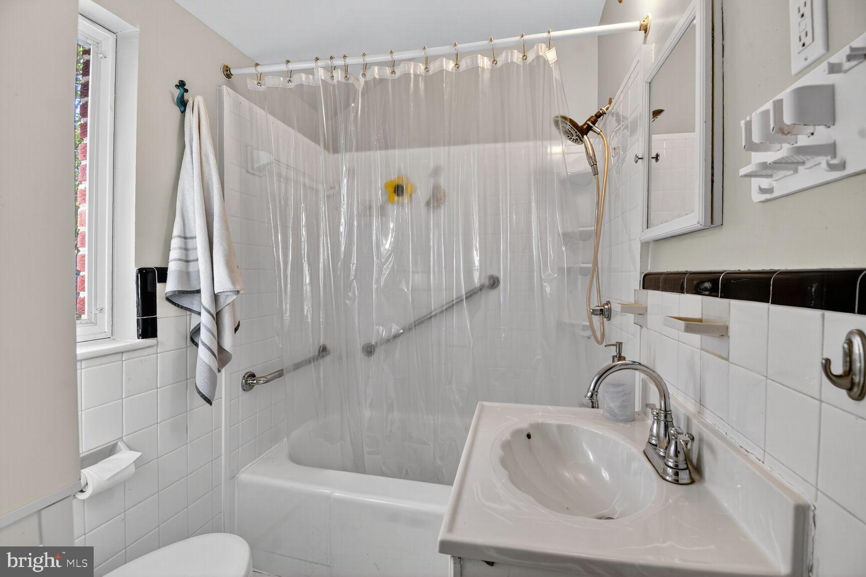 10021 Tenbrook Drive Silver Spring, MD 20901 - Photo 12 of 21 a bathroom with a sink a toilet and a bathtub