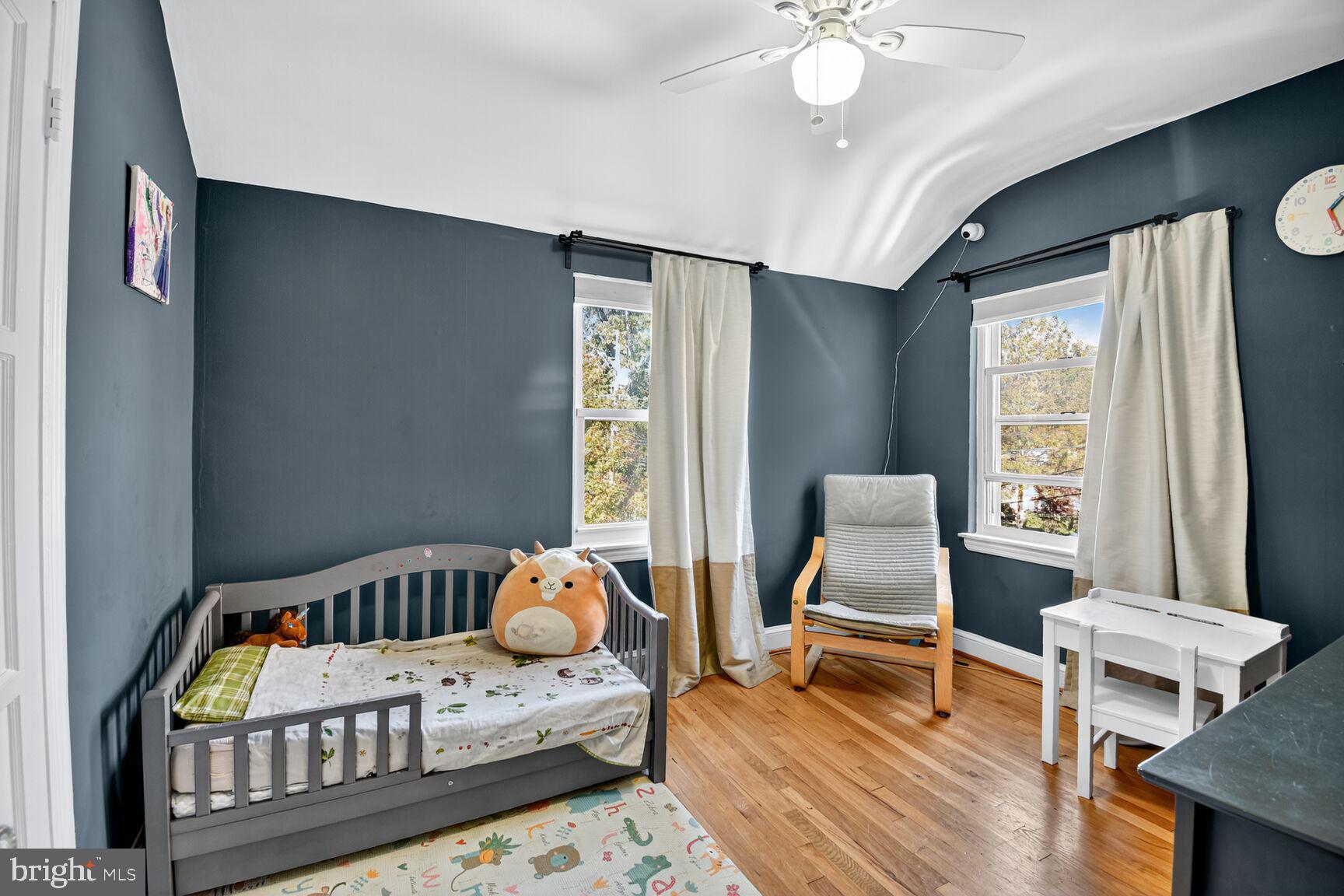 10021 Tenbrook Drive Silver Spring, MD 20901 - Photo 13 of 21 a bedroom with a bed and a chandelier