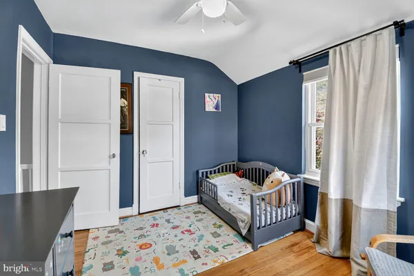 a bedroom with furniture and baby crib
