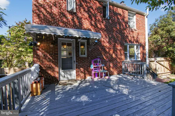 a view of a house with barbeque outdoor seating