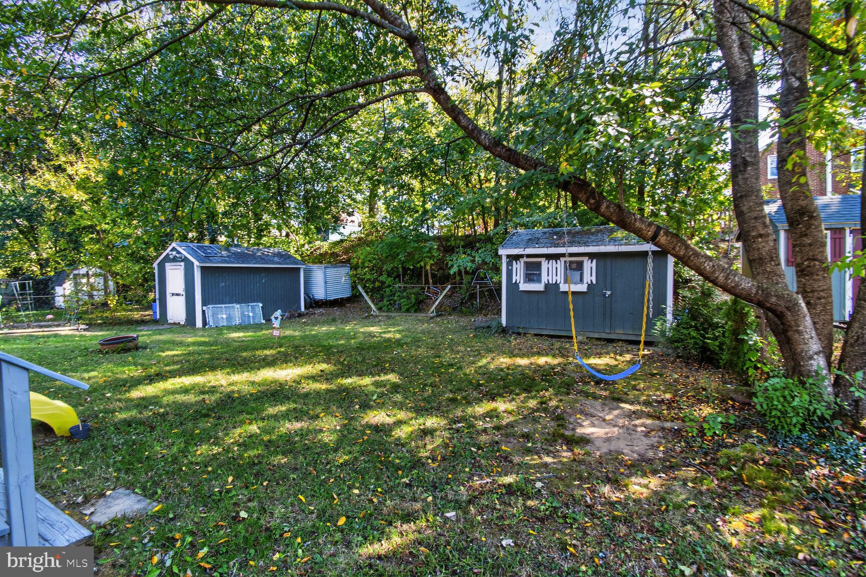 10021 Tenbrook Drive Silver Spring, MD 20901 - Photo 20 of 21 a view of a house with a yard and large trees