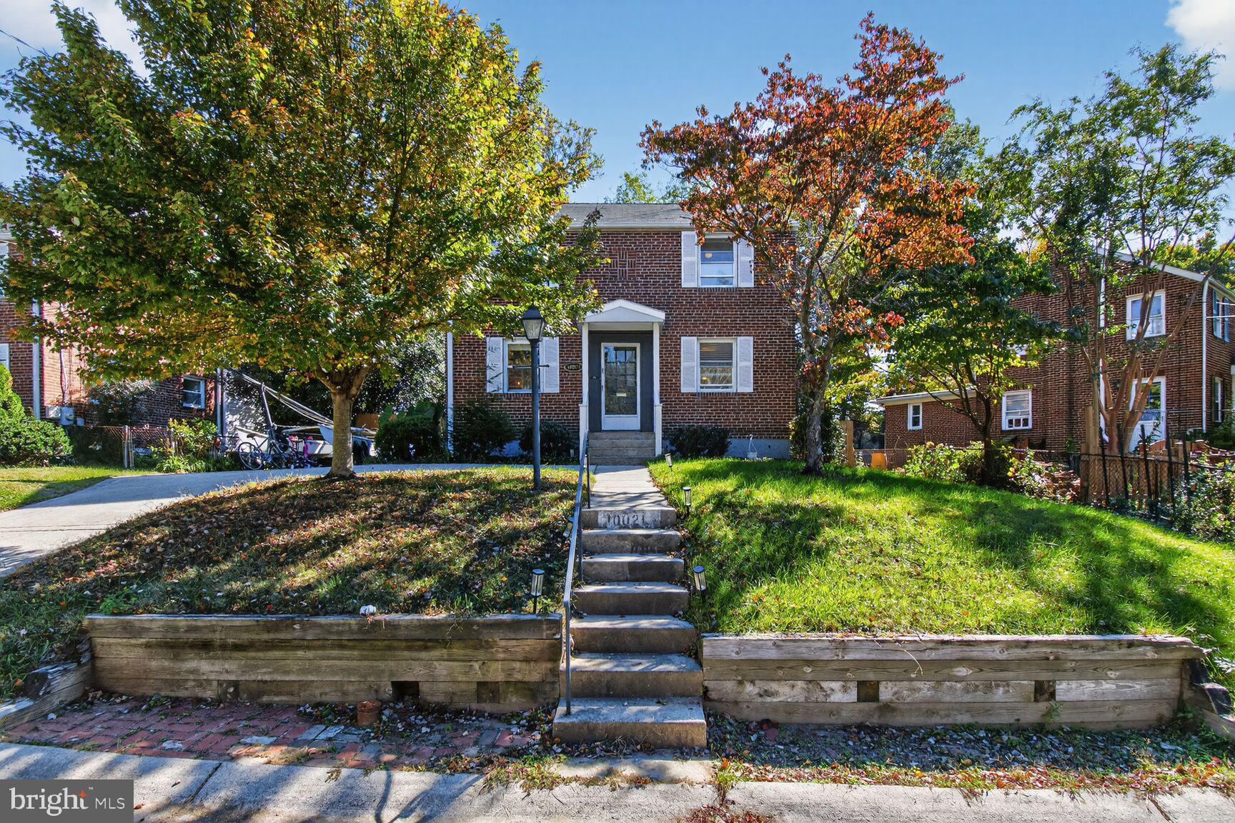 10021 Tenbrook Drive Silver Spring, MD 20901 - Photo 2 of 21 a front view of a house with garden