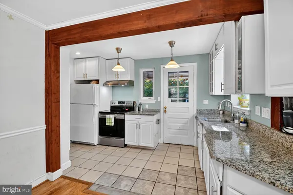a kitchen with a sink stainless steel appliances and cabinets