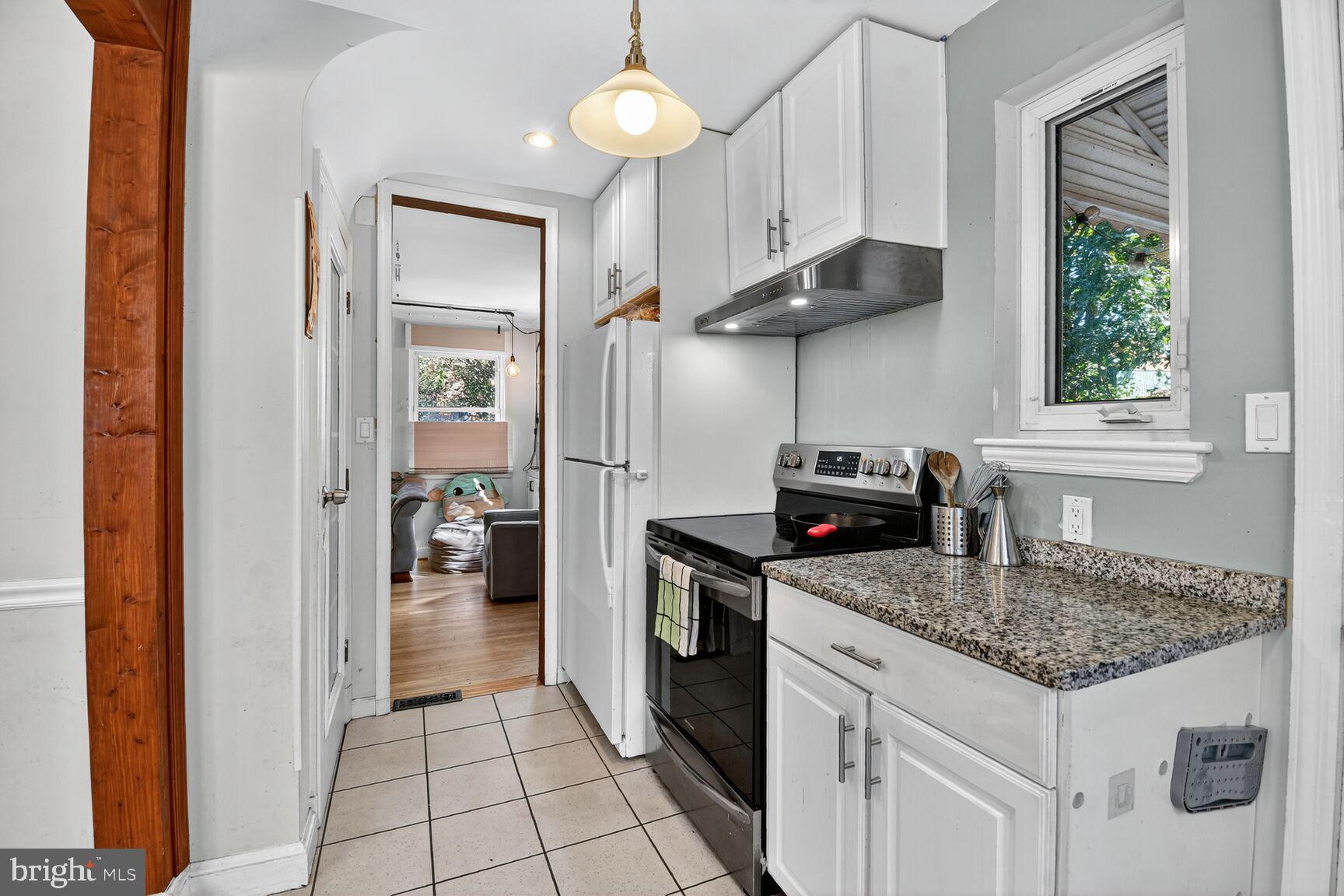 10021 Tenbrook Drive Silver Spring, MD 20901 - Photo 10 of 21 a kitchen with stainless steel appliances granite countertop a sink stove and refrigerator