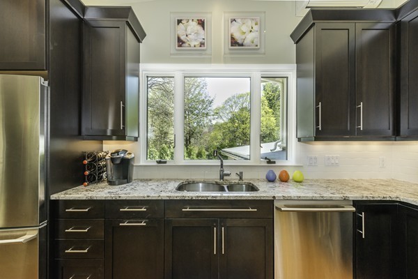23 Mason Street Lexington, MA 02421 - Photo 6 of 24 a kitchen with granite countertop a sink and a refrigerator
