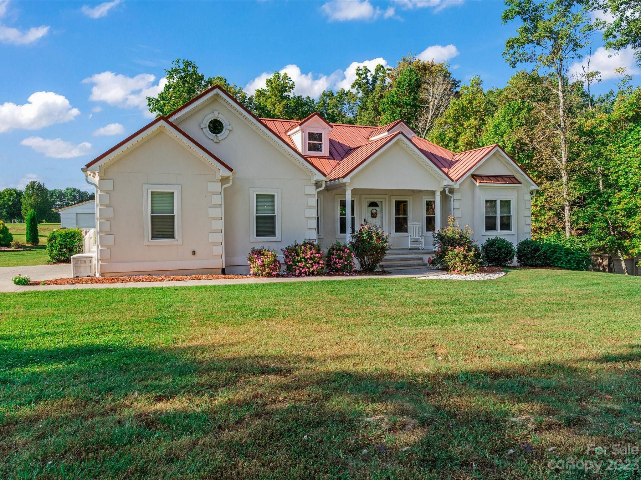 a front view of house with yard and green space
