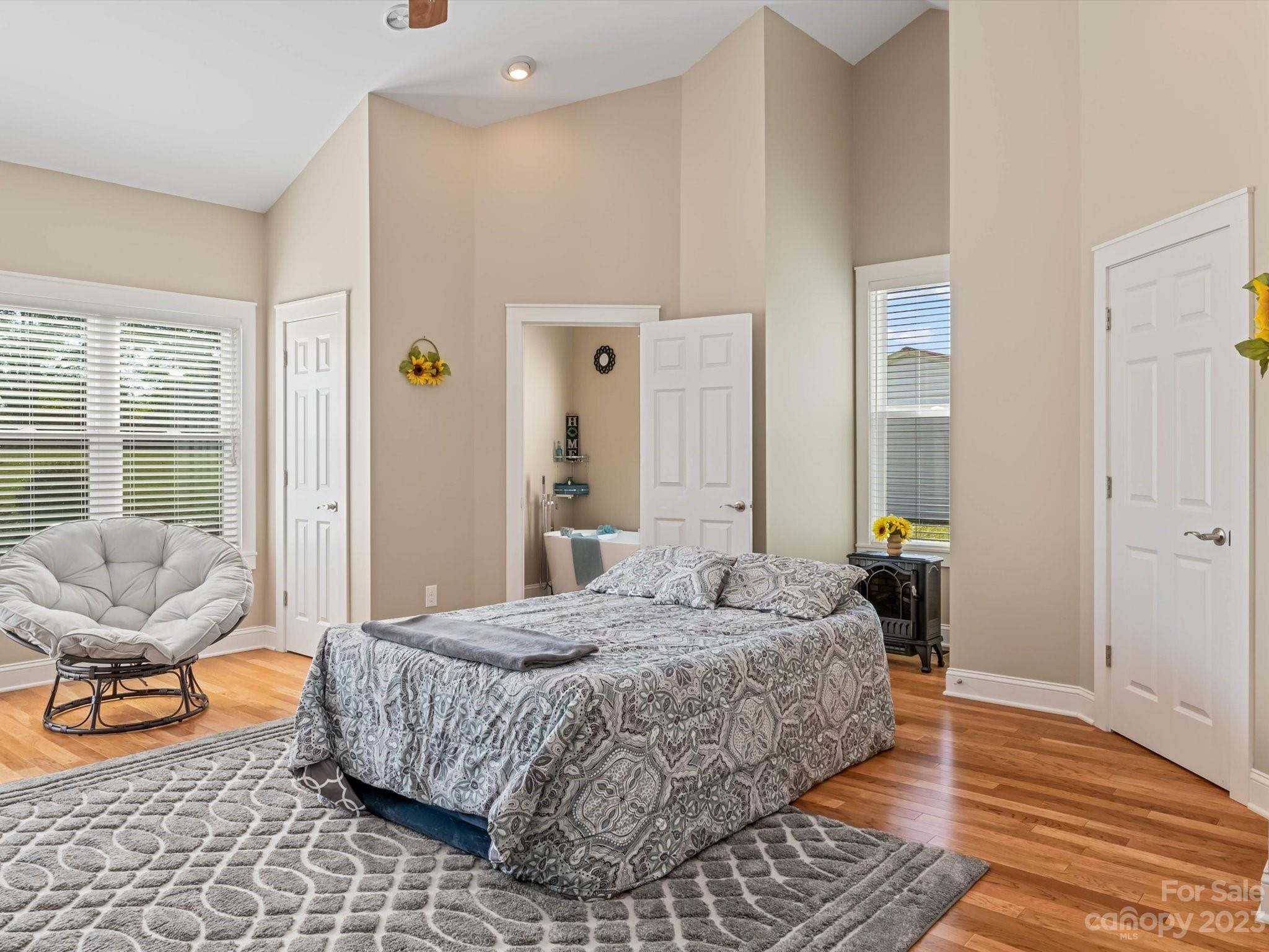 125 Boulder Ridge Drive State Road, NC 28676 - Photo 14 of 39 a bedroom with a bed and wooden floor