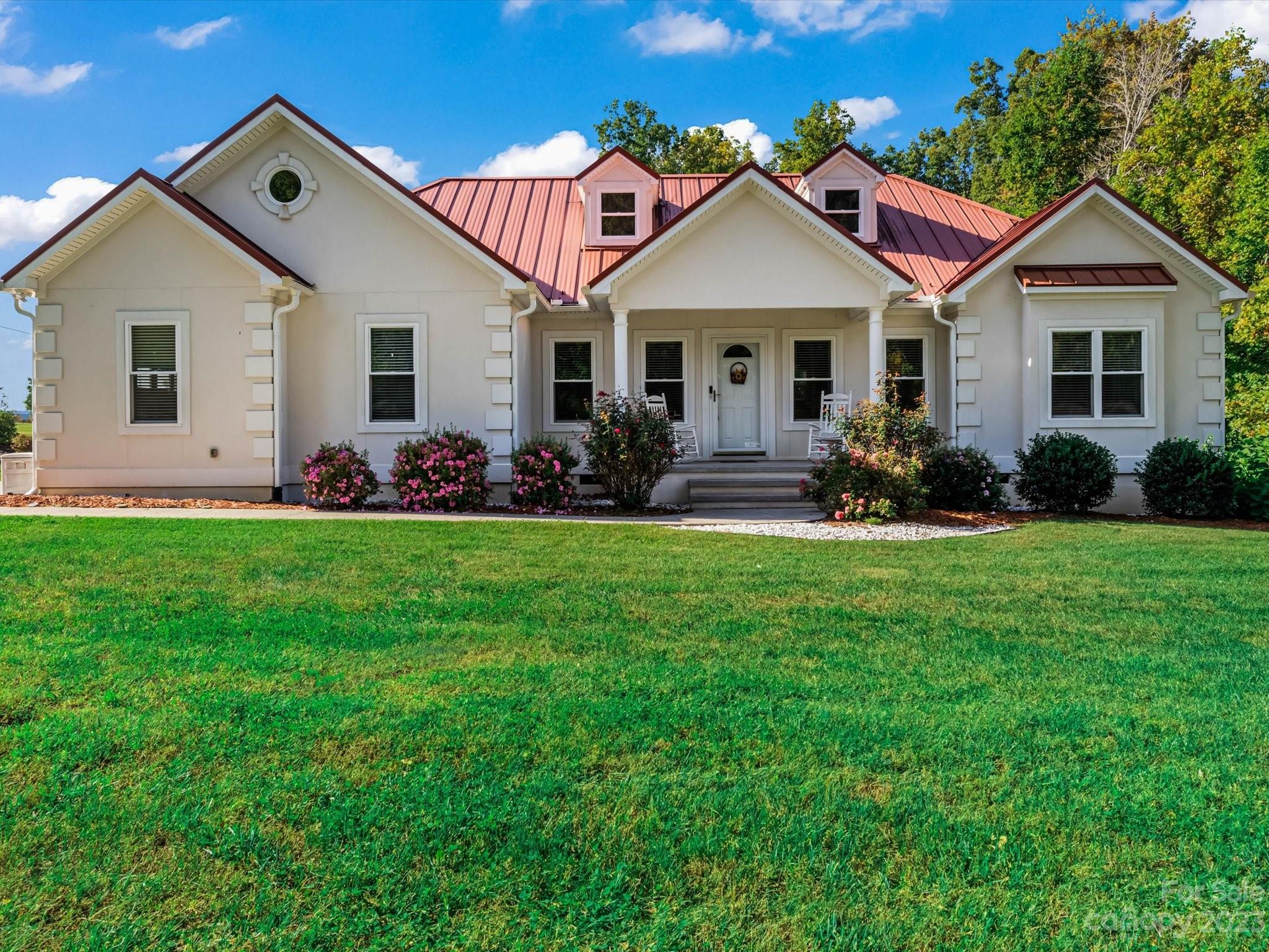 125 Boulder Ridge Drive State Road, NC 28676 - Photo 2 of 39 a front view of a house with garden and yard
