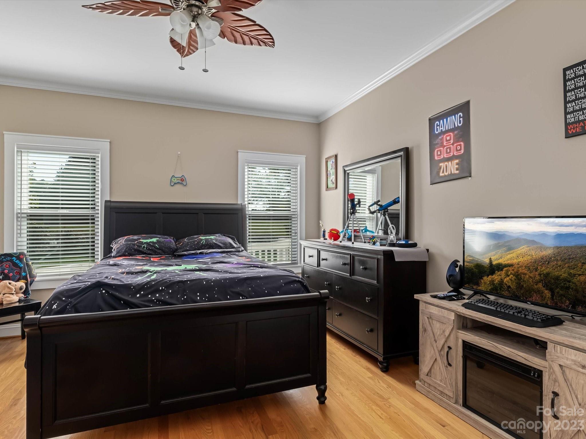 125 Boulder Ridge Drive State Road, NC 28676 - Photo 21 of 39 a bedroom with a bed and a flat screen tv