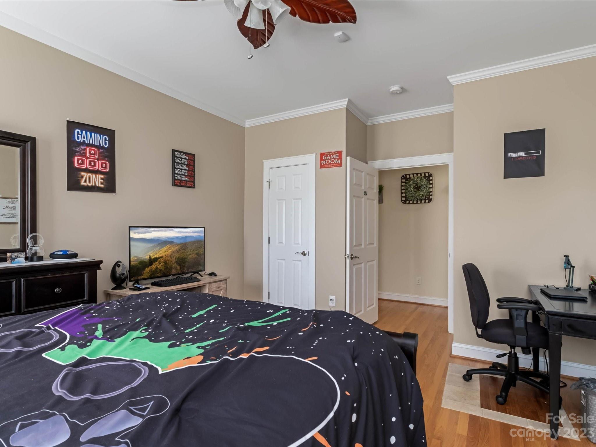 125 Boulder Ridge Drive State Road, NC 28676 - Photo 22 of 39 a bedroom with a bed and a flat screen tv
