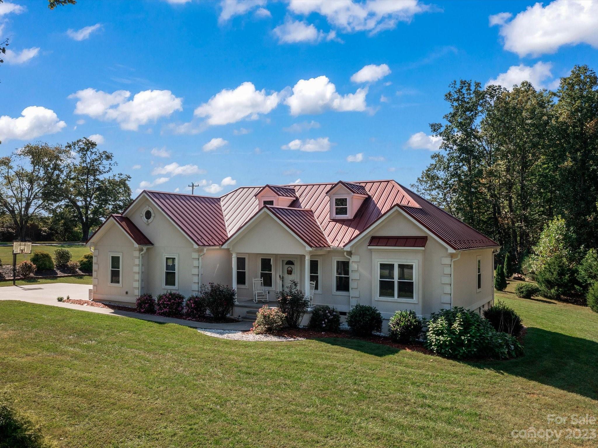 125 Boulder Ridge Drive State Road, NC 28676 - Photo 28 of 39 a front view of a house with a garden and yard