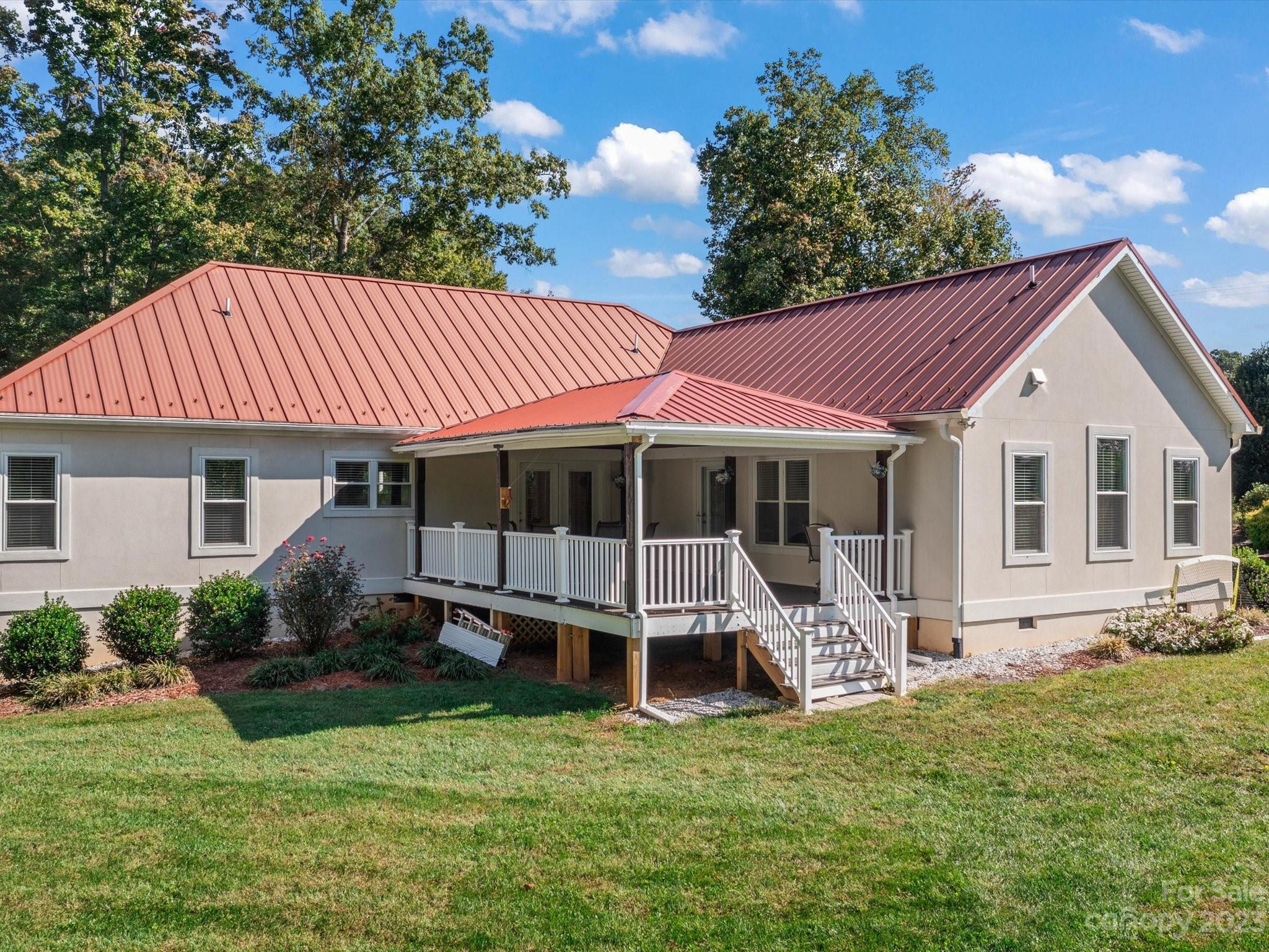 125 Boulder Ridge Drive State Road, NC 28676 - Photo 33 of 39 a front view of a house with garden