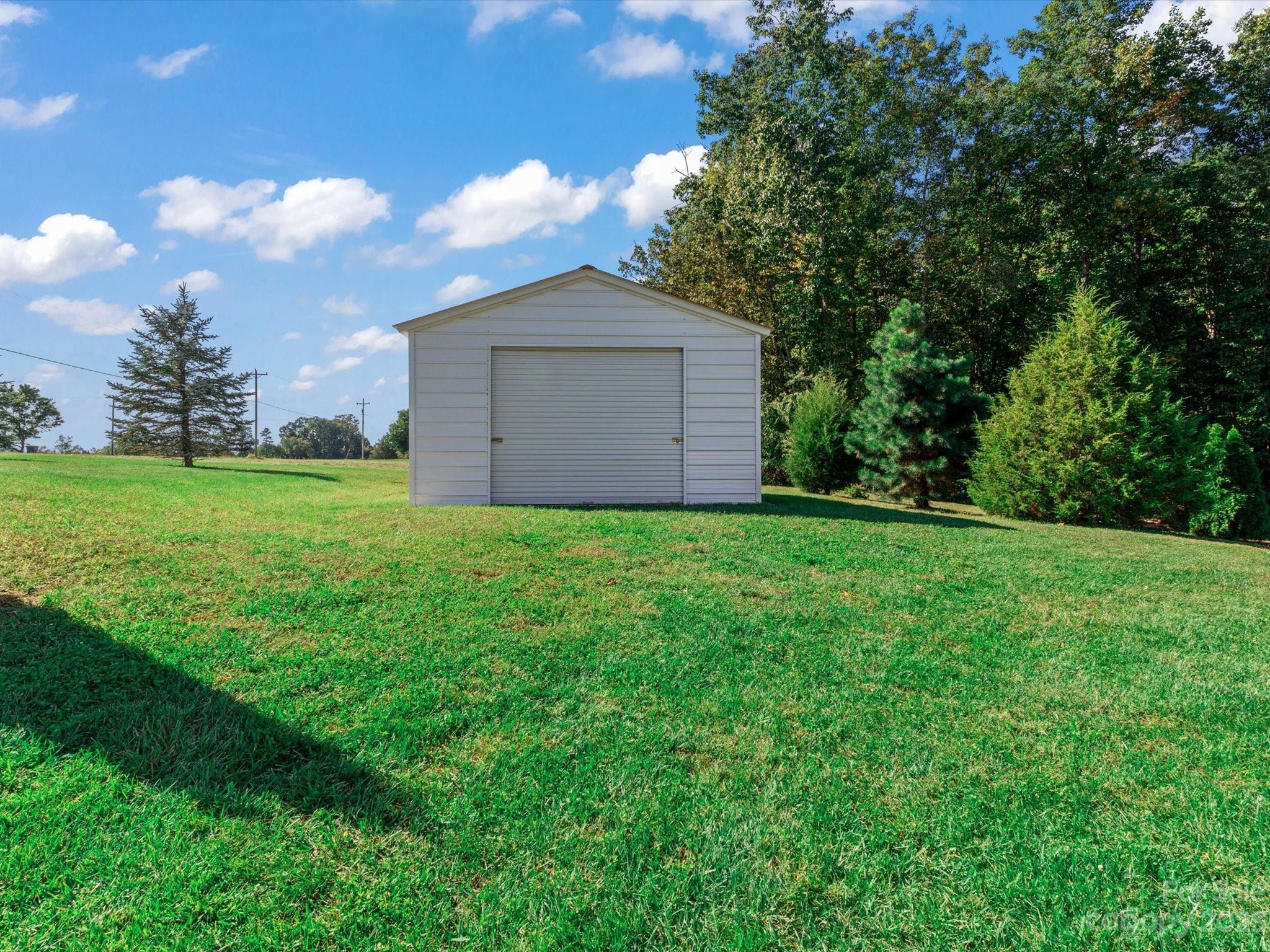 125 Boulder Ridge Drive State Road, NC 28676 - Photo 35 of 39 a view of a house with a yard and large tree