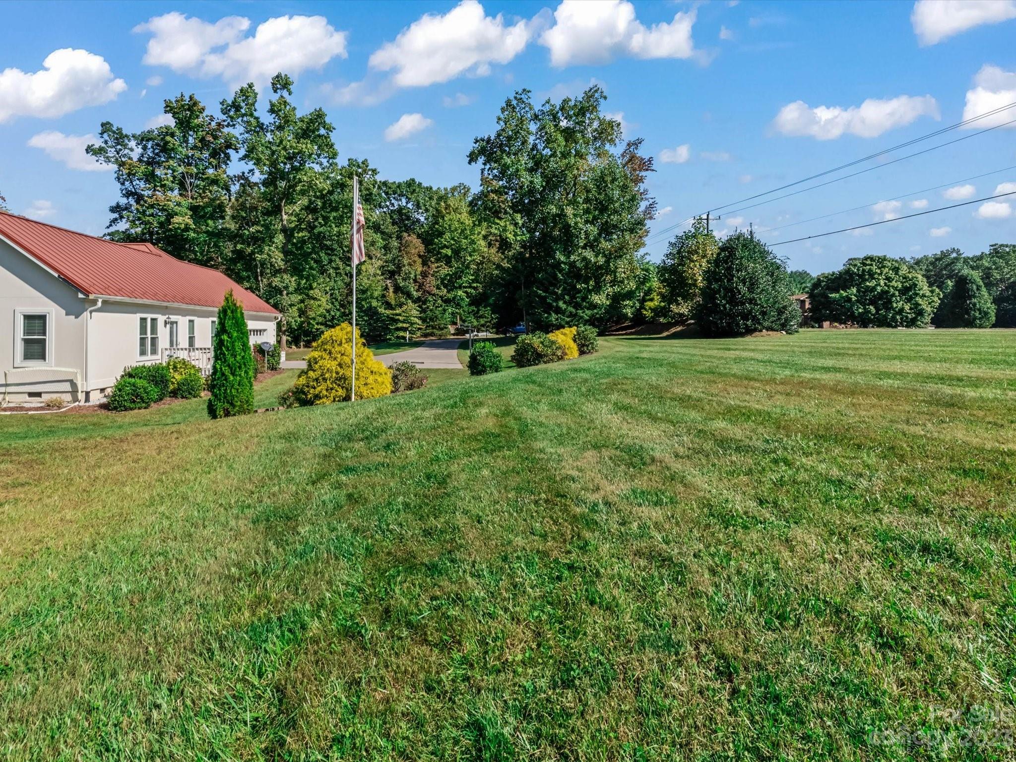 125 Boulder Ridge Drive State Road, NC 28676 - Photo 36 of 39 a view of a house with a backyard and a garden