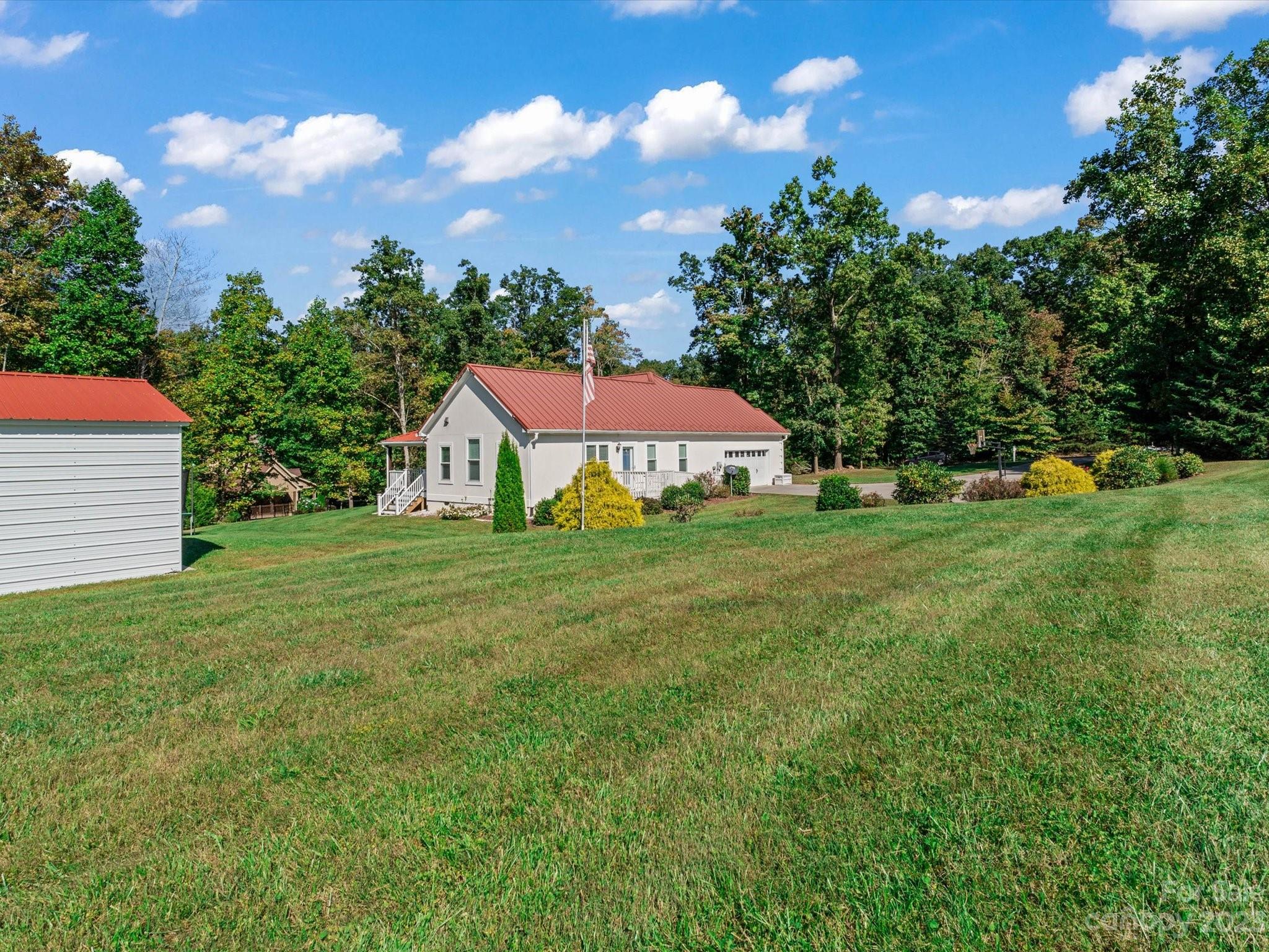 125 Boulder Ridge Drive State Road, NC 28676 - Photo 37 of 39 a view of an house with backyard and garden